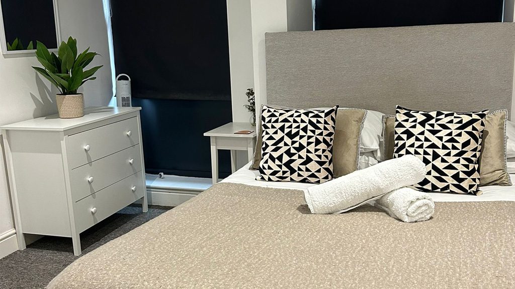 Double bed, cozy seating, and smart TV in the living and sleeping area of Studio 3