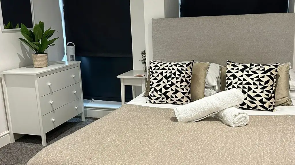 Double bed, cozy seating, and smart TV in the living and sleeping area of Studio 3 in serviced apartments hereford