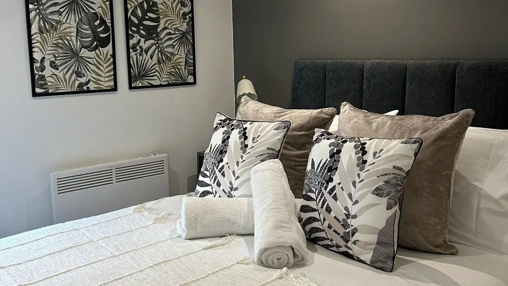 Inviting double bed, cozy lounge, and smart TV in Studio 4, serviced apartments Hereford.