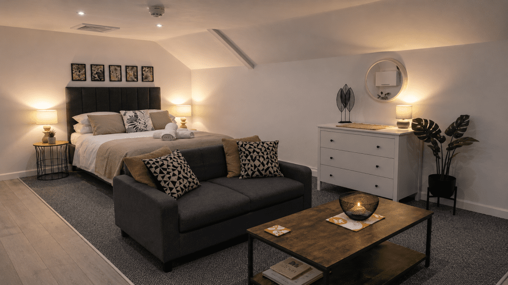 Comfortable double bed and peaceful seating area in Studio 6 of serviced apartments Hereford