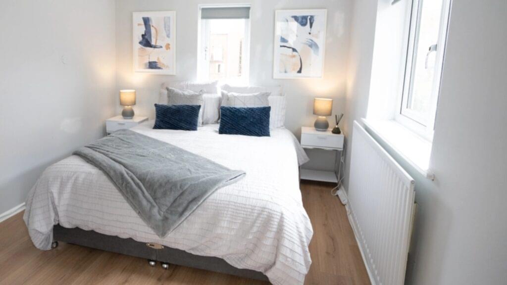 Spacious double bedroom with a comfortable bed and scenic window views in a luxury Stratford-Upon-Avon accommodation.