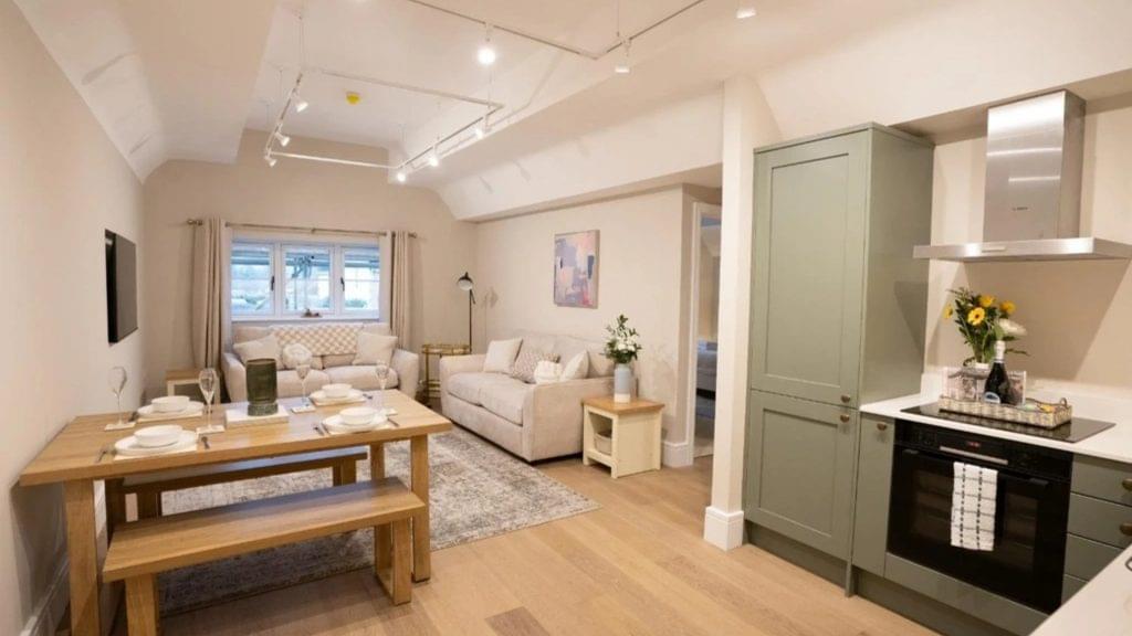 Spacious living area with a double sofa bed and dining area in the luxury accommodation Broadway Cotswolds