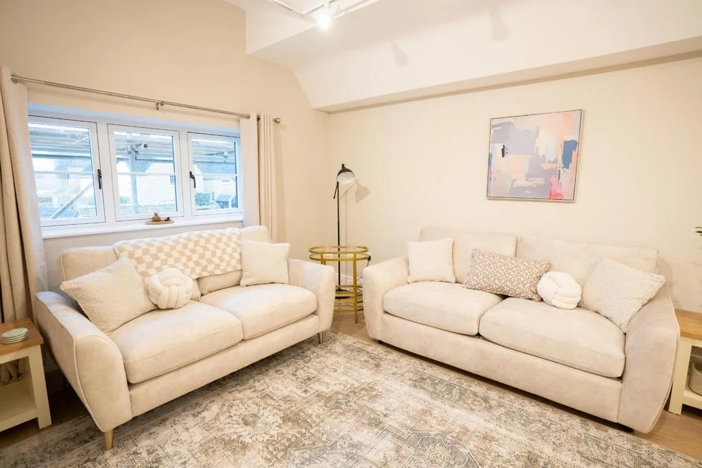 Elegant luxury room in Broadway featuring large light sofas, perfect for relaxing.