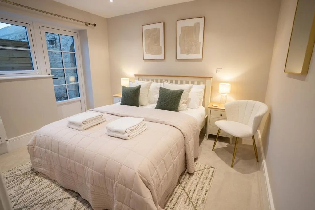 Comfortable double bedroom with a cozy bed and panoramic night view of city lights in Worcestershire